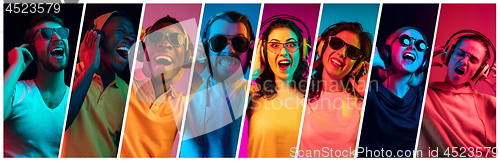 Image of Beautiful young people in neon light isolated on multicolored studio background