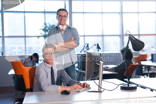 Image of Two Business People Working With computer in office