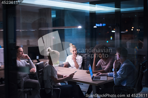 Image of Multiethnic startup business team in night office