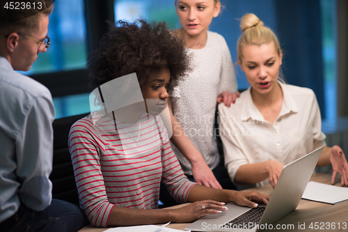 Image of Multiethnic startup business team in night office