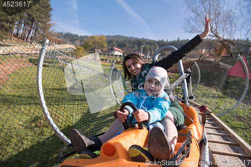Image of mother and son enjoys driving on alpine coaster