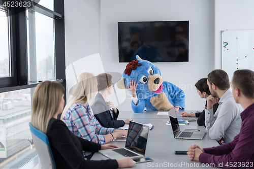 Image of boss dresed as bear having fun with business people in trendy of