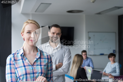 Image of Business People Working With Tablet in startup office