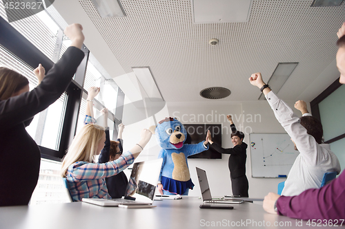 Image of boss dresed as bear having fun with business people in trendy of