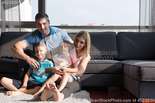 Image of happy young couple spending time with kids