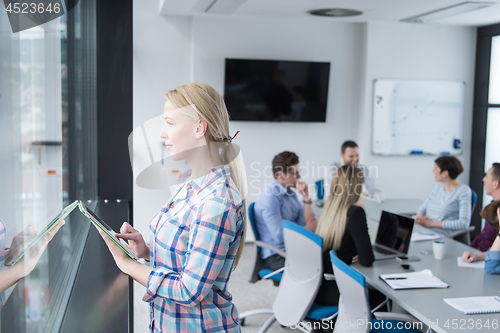 Image of Pretty Businesswoman Using Tablet In Office Building by window