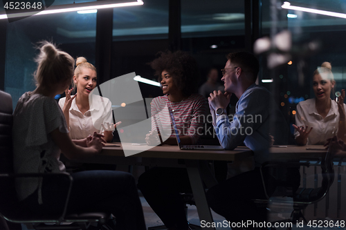 Image of Multiethnic startup business team in night office