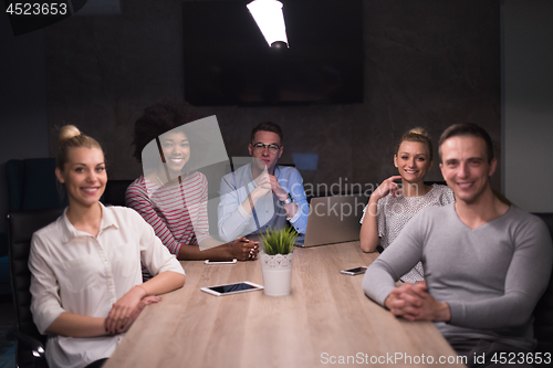 Image of Multiethnic startup business team in night office