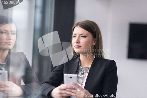 Image of Business Girl Standing In A Modern Building Near The Window With