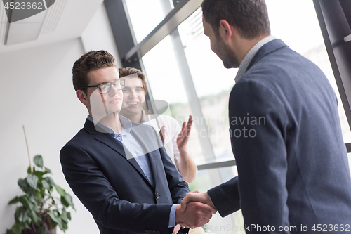 Image of cloasing the deal in modern office interior