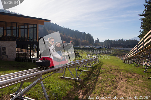 Image of couple enjoys driving on alpine coaster