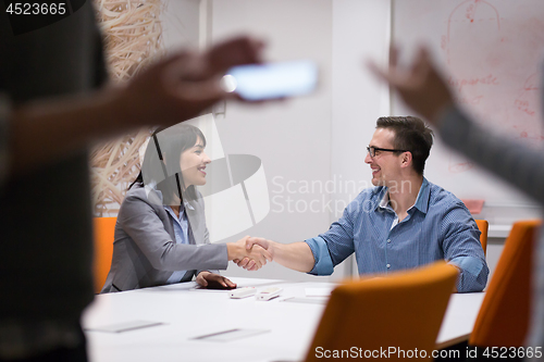 Image of cloasing the deal in modern office interior