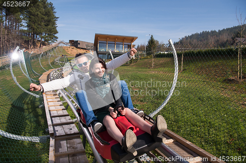 Image of couple enjoys driving on alpine coaster