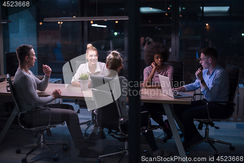 Image of Multiethnic startup business team in night office