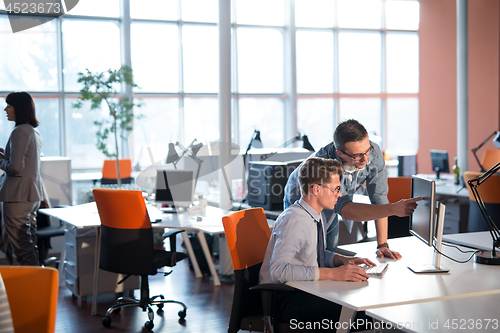 Image of Two Business People Working With computer in office