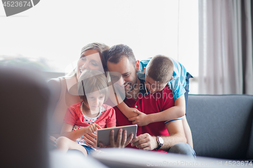 Image of happy young couple spending time with kids