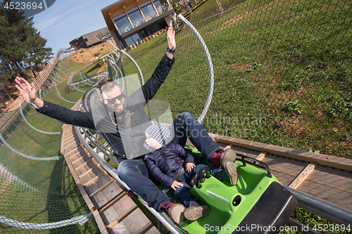 Image of father and son enjoys driving on alpine coaster