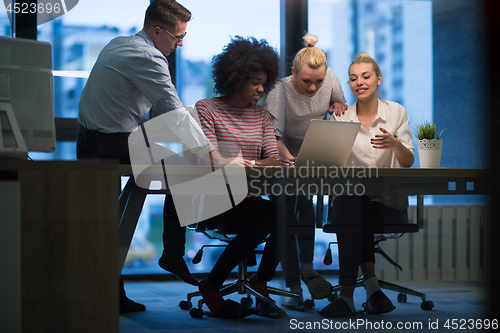 Image of Multiethnic startup business team in night office