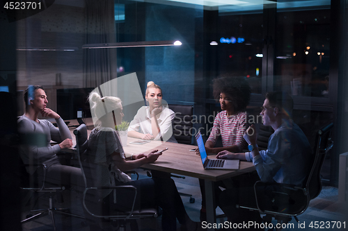 Image of Multiethnic startup business team in night office