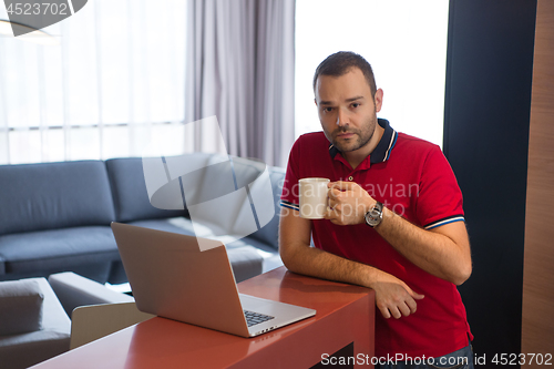 Image of man drinking coffee enjoying relaxing lifestyle