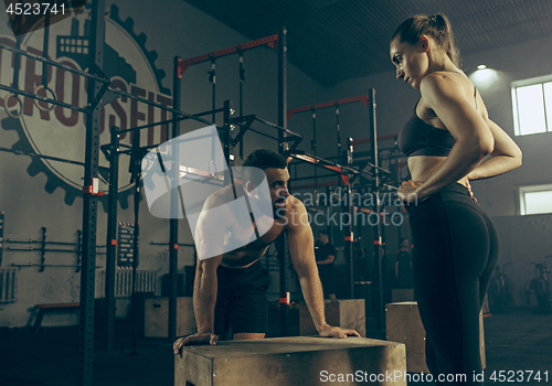 Image of Man during exercises in the fitness gym. CrossFit.