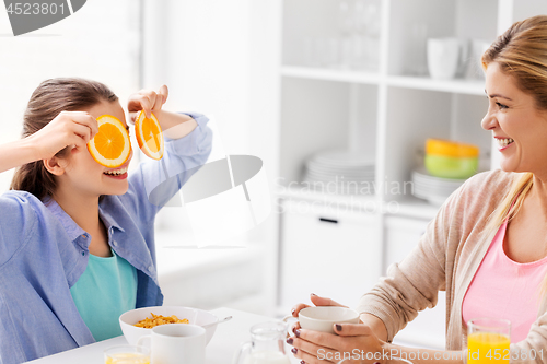 Image of happy family having breakfast at home kitchen