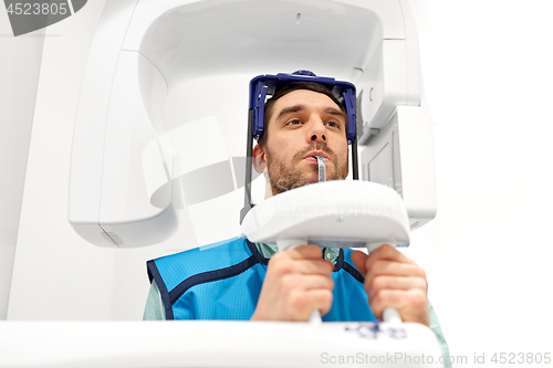 Image of patient having x-ray scanning at dental clinic