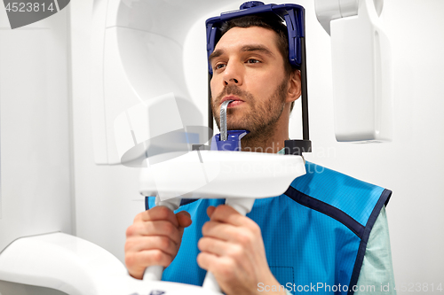 Image of patient having x-ray scanning at dental clinic