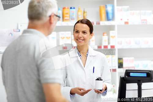 Image of apothecary and senior customer at pharmacy