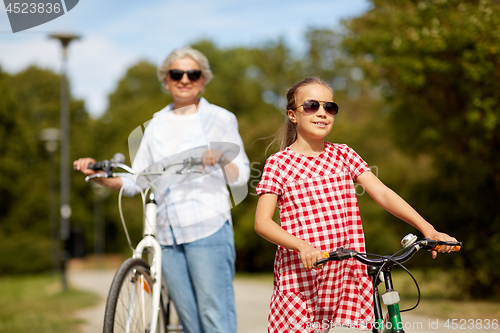 Image of grandmother and granddaughter with bicycles