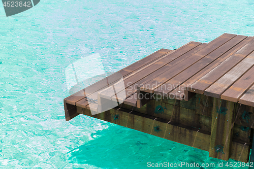 Image of wooden pier with stair in sea water