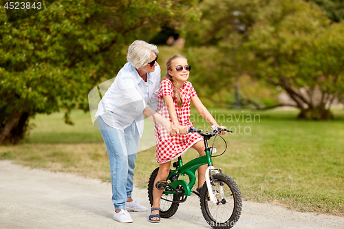 Image of grandmother and granddaughter with bicycles