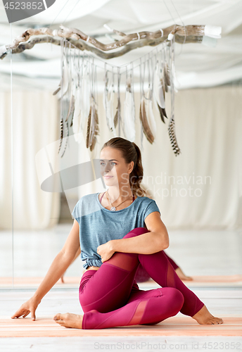 Image of woman doing yoga exercise at studio