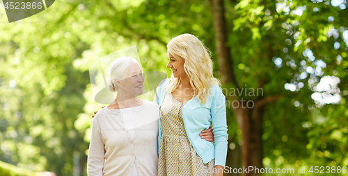 Image of daughter with senior mother hugging at park