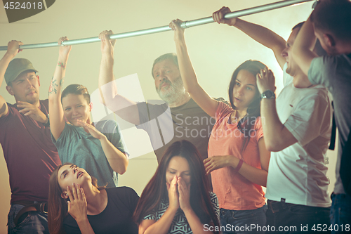 Image of Sweaty armpits. Sweaty man. Bus. Public transport. The unhappy people near man