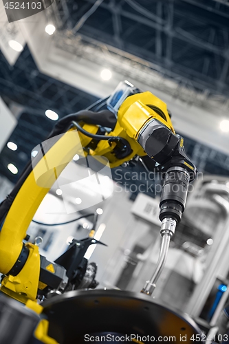 Image of Automatic robot arm working in industrial environment