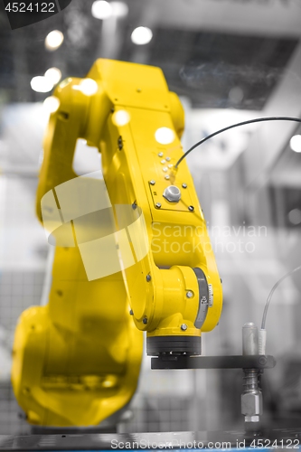 Image of Automatic robot arm working in industrial environment