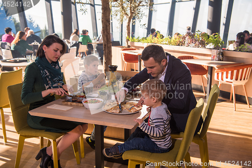 Image of happy family enjoying lunch time together