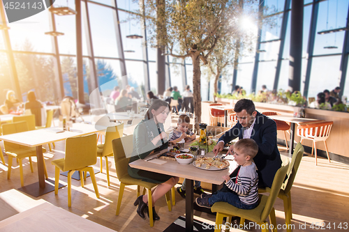 Image of happy family enjoying lunch time together