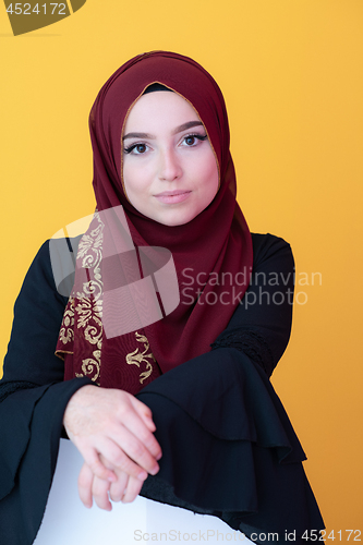 Image of muslim woman portrait with hijab on yellow background