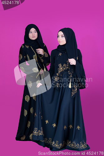 Image of two hijab muslim woman on pink background