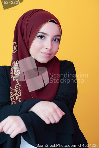 Image of muslim woman portrait with hijab on yellow background