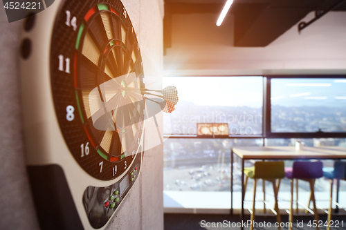 Image of Darts arrow hitting in the target center