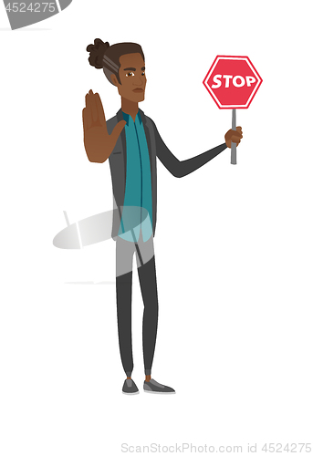 Image of Young african businessman holding stop road sign.