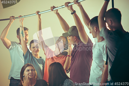 Image of Sweaty armpits. Sweaty man. Bus. Public transport. The unhappy people near man