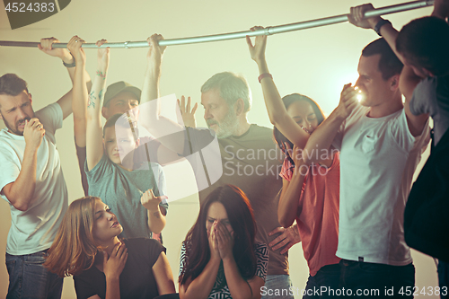 Image of Sweaty armpits. Sweaty man. Bus. Public transport. The unhappy people near man