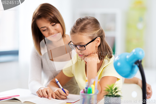 Image of mother and daughter doing homework together