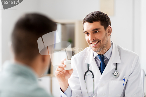 Image of doctor showing medicine to patient at hospital