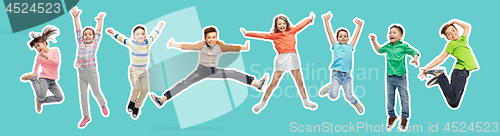 Image of happy kids jumping in air over blue background