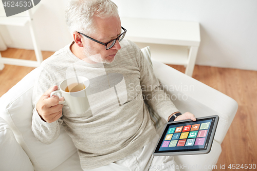 Image of old man with smart home icons on tablet computer